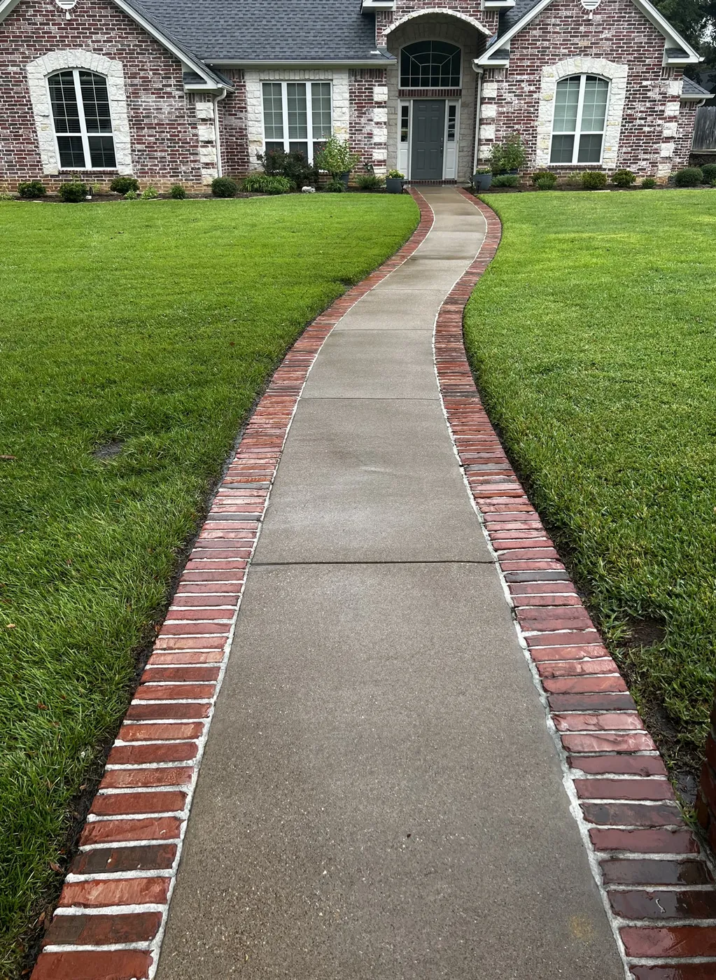 After: brick-edged front walkway surface cleaned by B&H