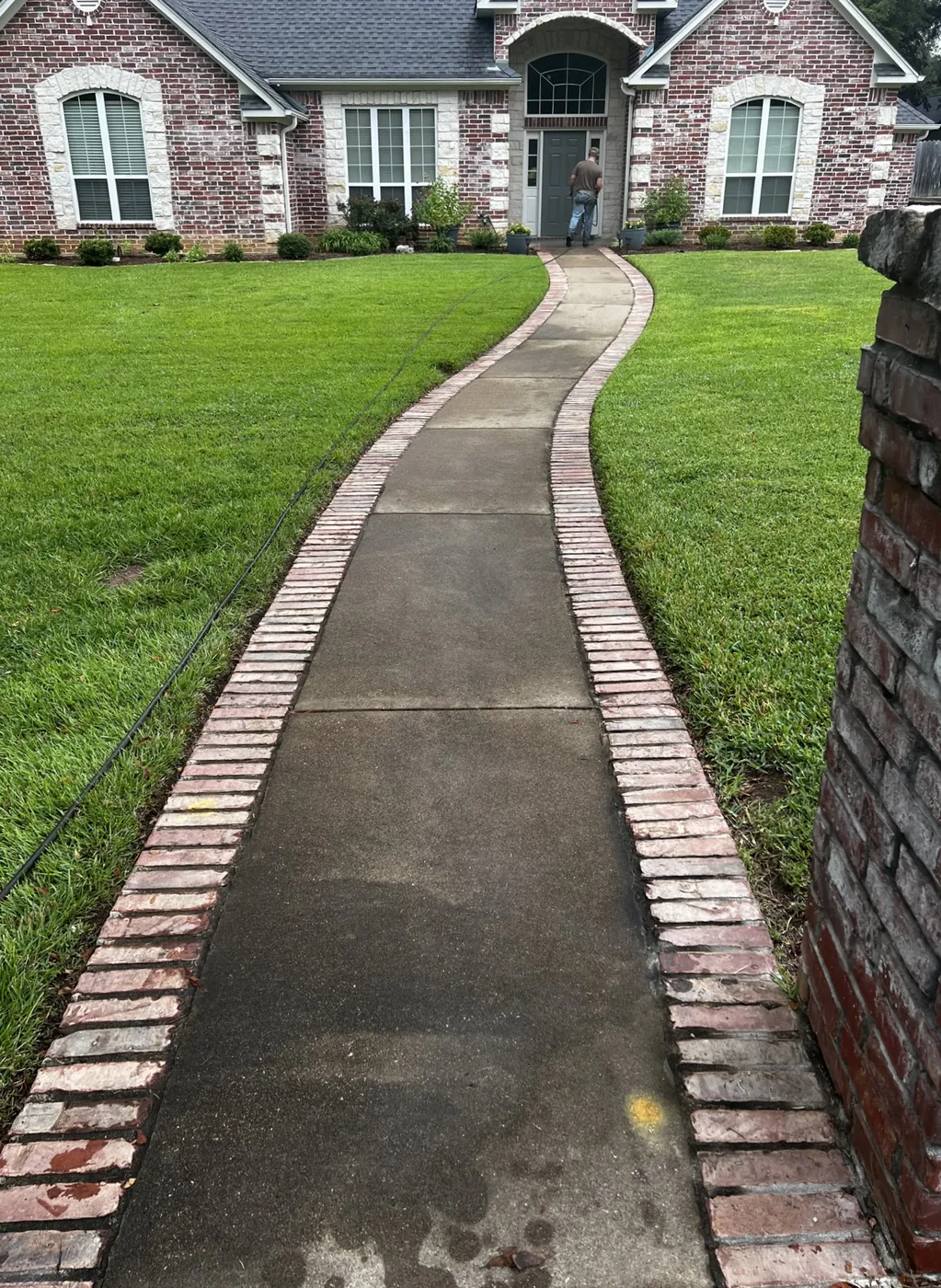 Before: brick-edged front walkway surface cleaned by B&H