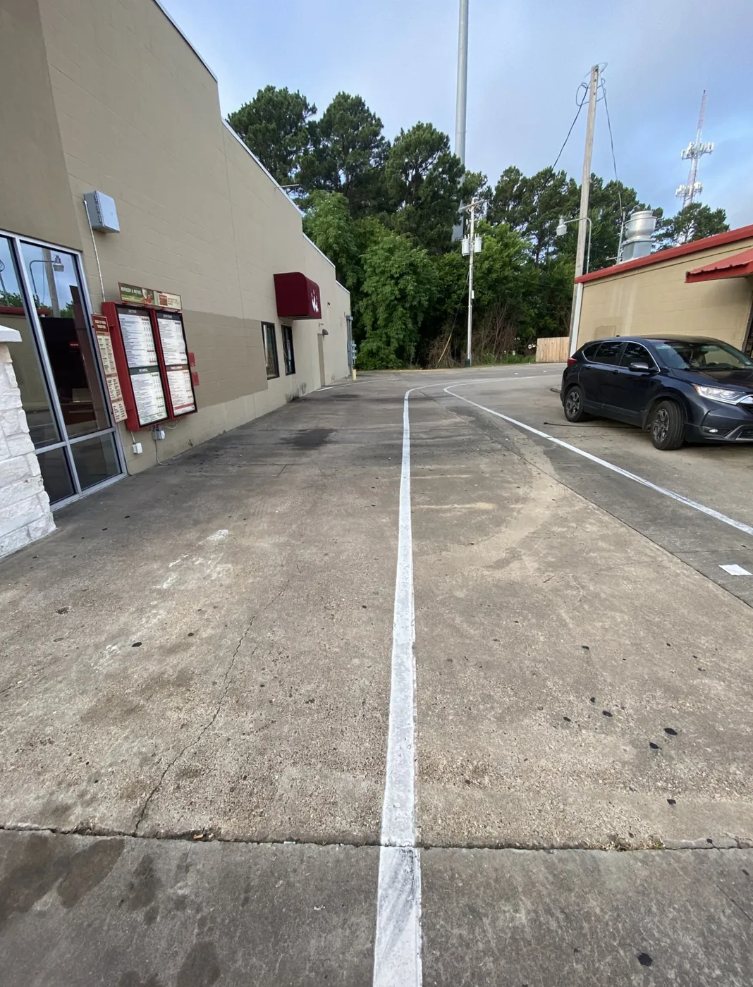 Before: restaurant drive lane and parking concrete cleaned by B&H