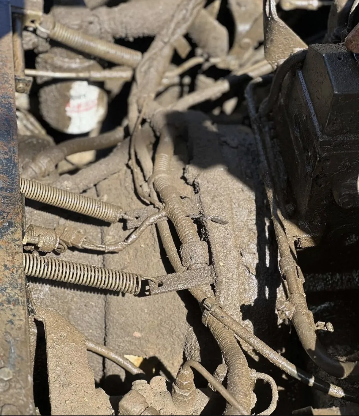 Before: heavy equipment engine compartment caked in mud, degreased by B&H