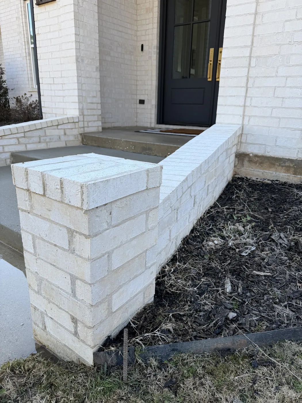 After: white brick front entry planter with mildew, washed by B&H