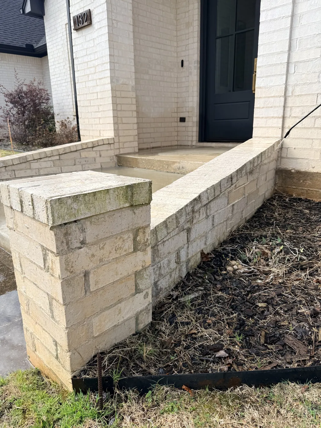 Before: white brick front entry planter with mildew, washed by B&H