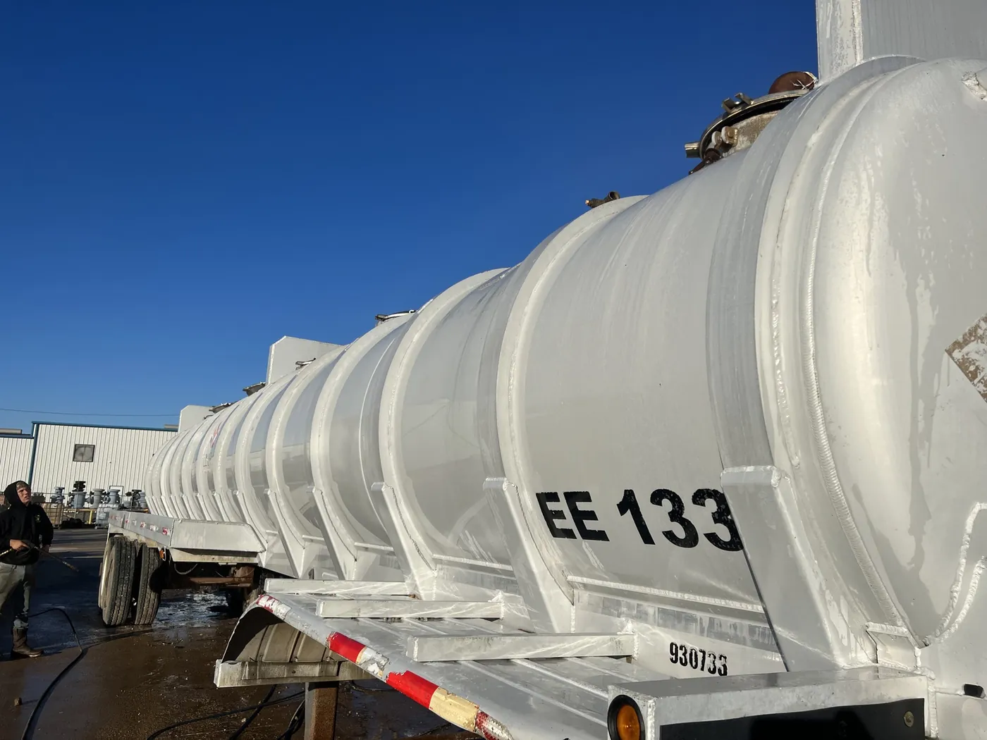 After: oilfield vacuum tanker trailer washed from dirty to bright white by B&H