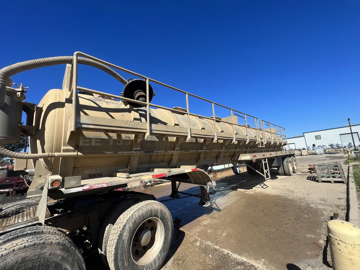 Before: oilfield vacuum tanker trailer washed from dirty to bright white by B&H