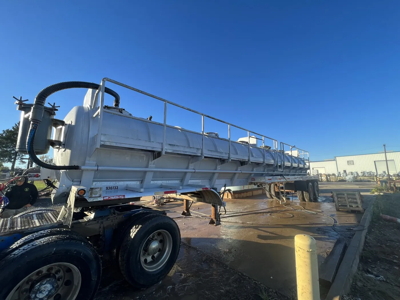 After: mud-covered vacuum tanker trailer washed bright white by B&H