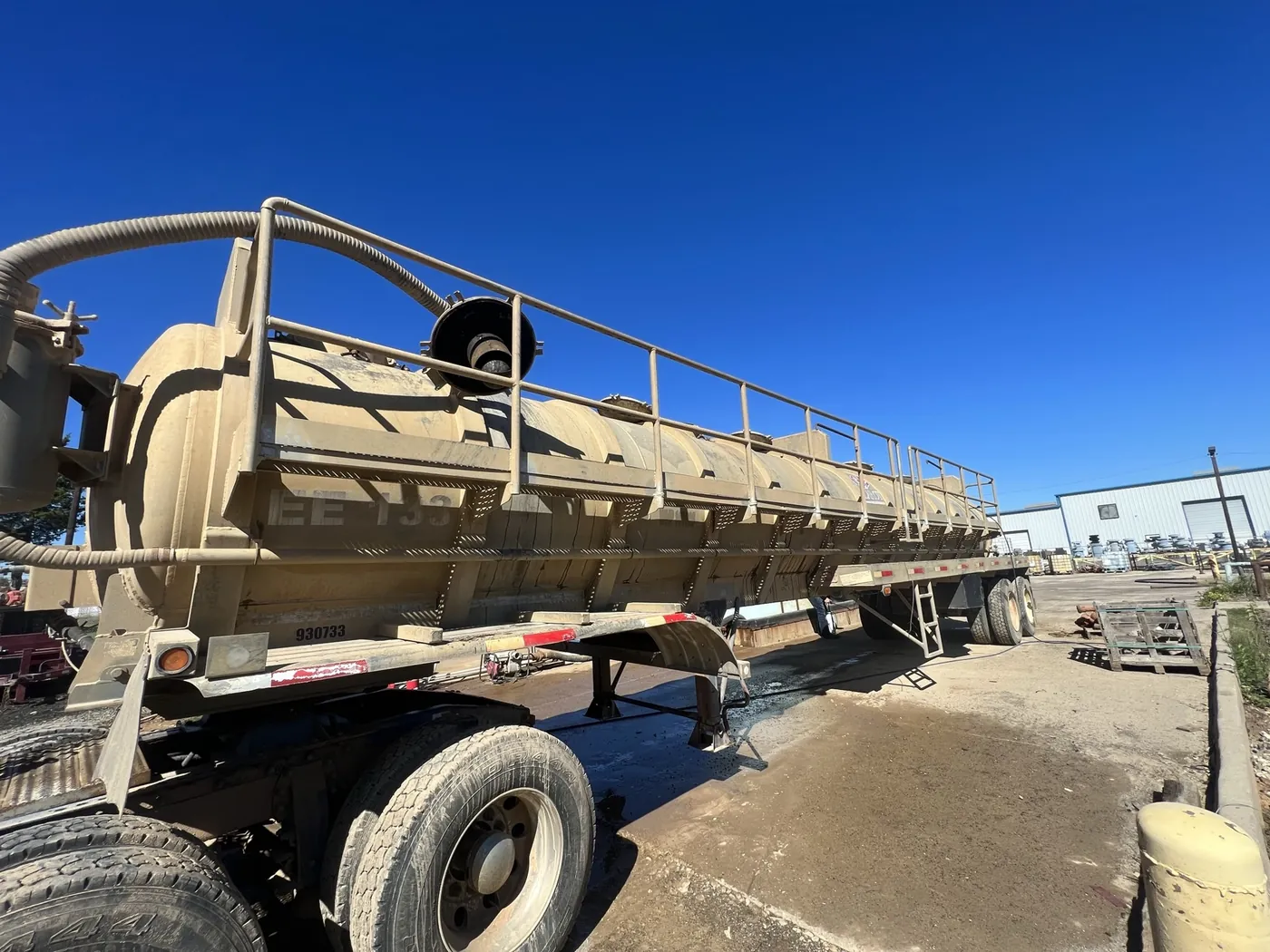 Before: mud-covered vacuum tanker trailer washed bright white by B&H