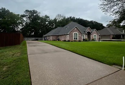 Long concrete driveway after a full pressure wash